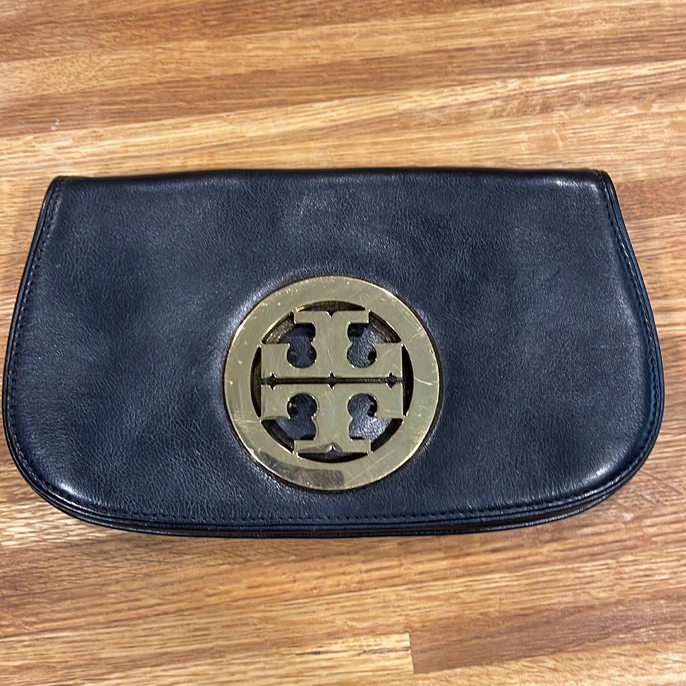 Tory Burch clutch. Used (please see all photos) is missing strap.